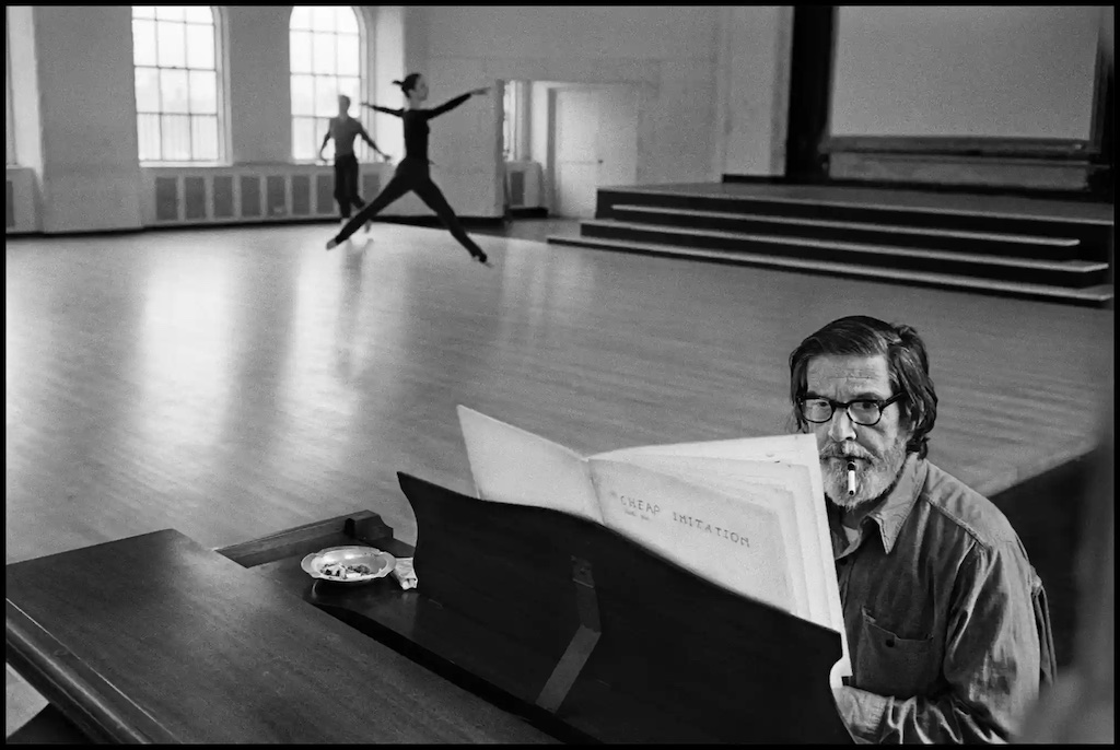 John Cage at the piano accompanying a rehearsal of Merce Cunningham's dance "Second hand"